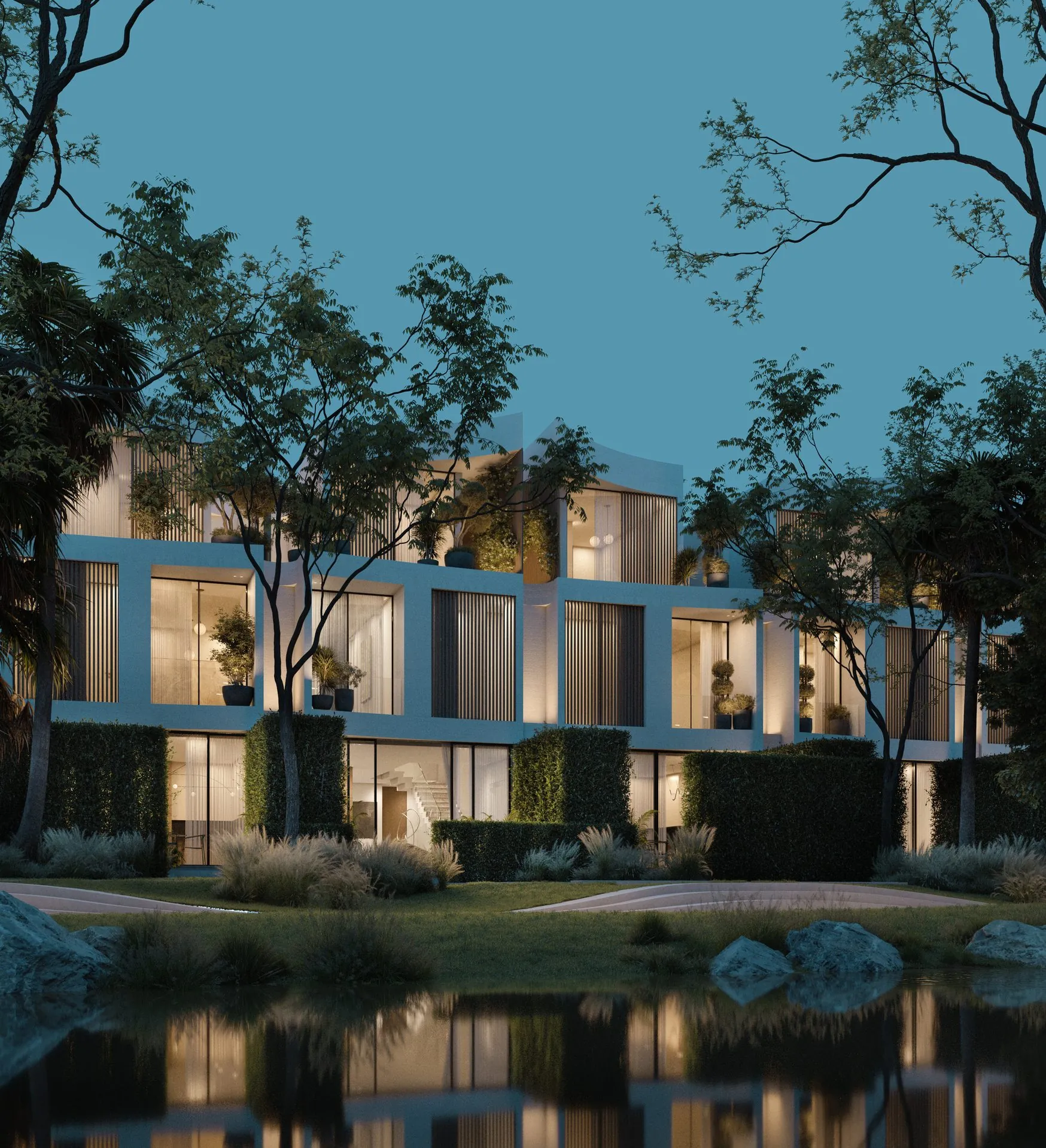 Façade de villa et étang la nuit